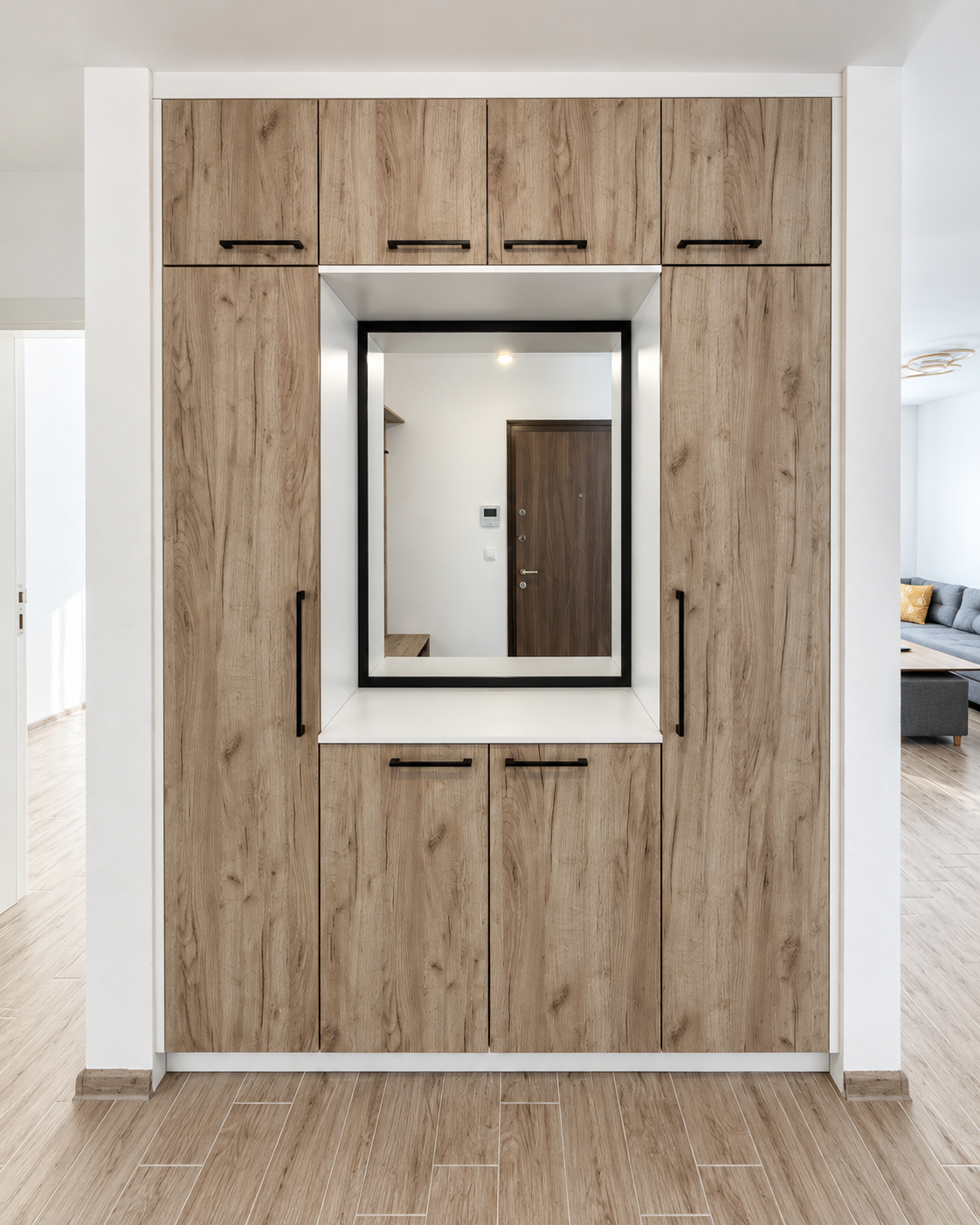 modern oak entryway cabinetry with mirroralcove